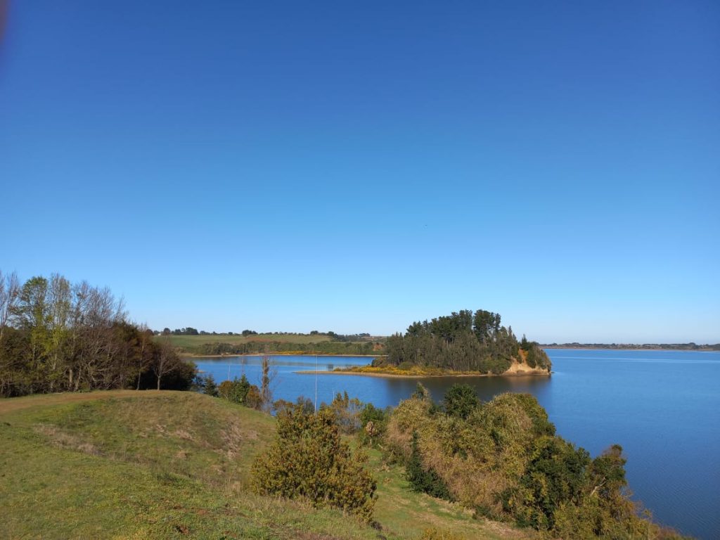 A view of Lake Budi, Chile, under blue skies